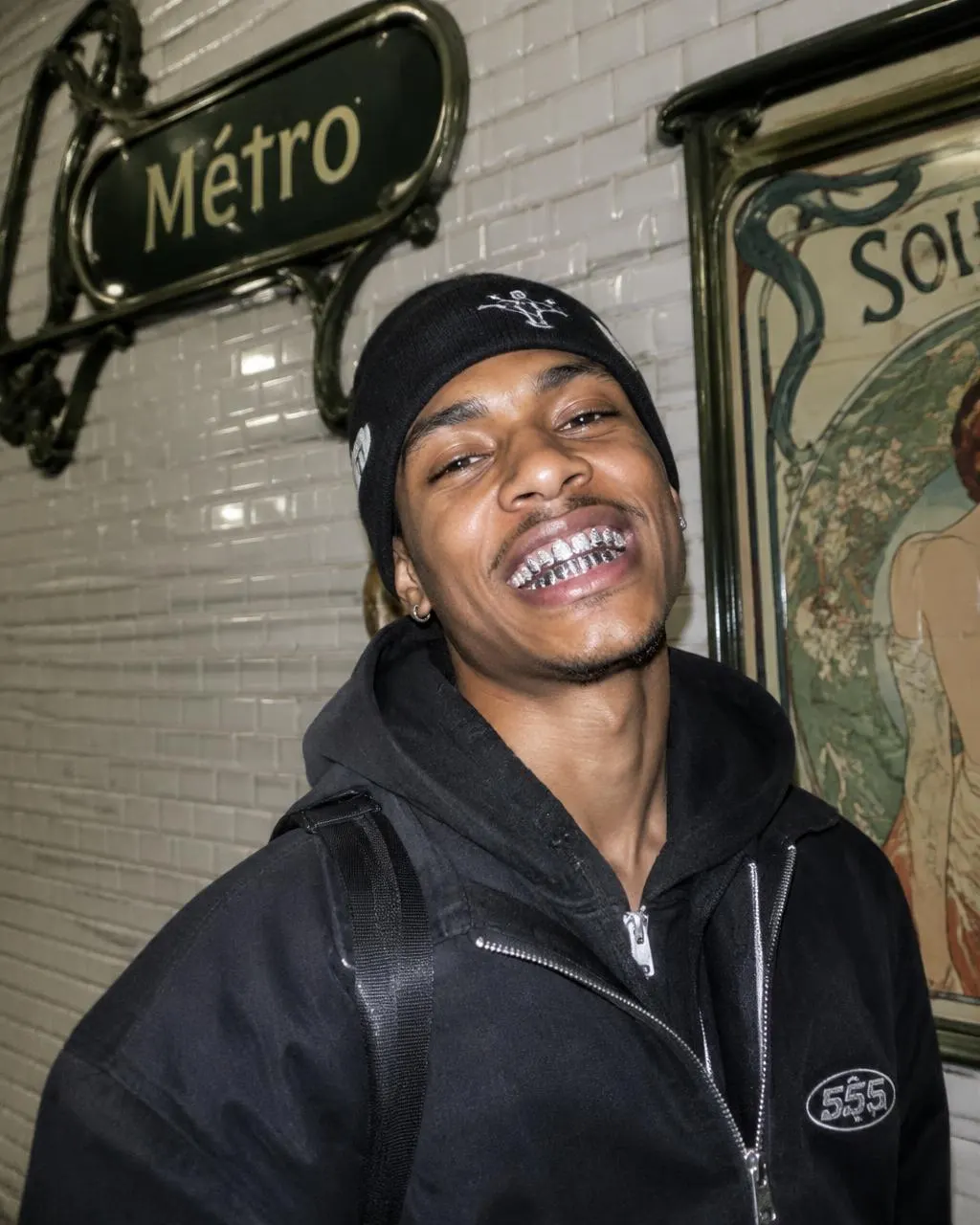 Custom silver grillz worn in the Paris métro