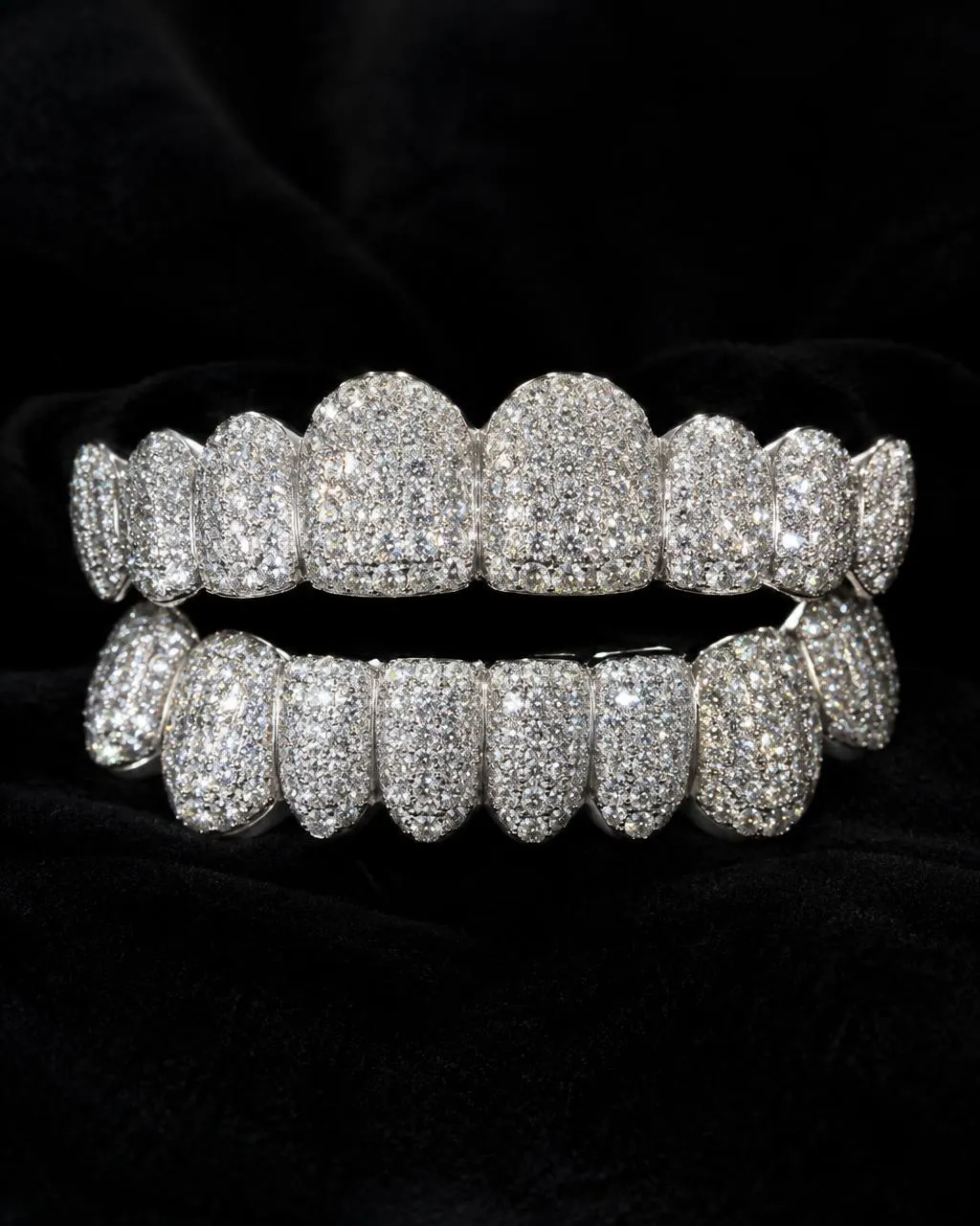 White gold top and bottom grillz fully pavé-set with diamonds on black velvet